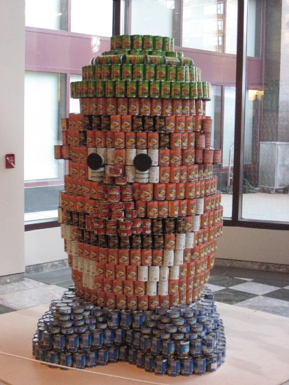 Mr. Potato head made from cans of blue for feet, orange for body and green for hat at the Canstruction 2010 show