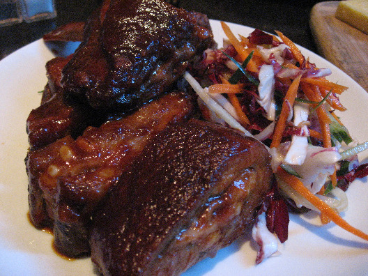 Community Food & Juice in NYC serves up delicious baby back ribs with a side of colorful slaw
