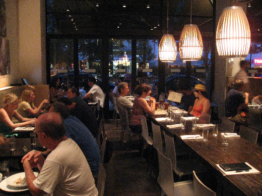 Community Food and Juice in NYC interior with cafeteria style rows of wood tables and chairs