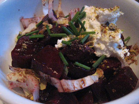 Community Food and Juice NYC beet salad, with bitter greens, topped with goat cheese and scallions