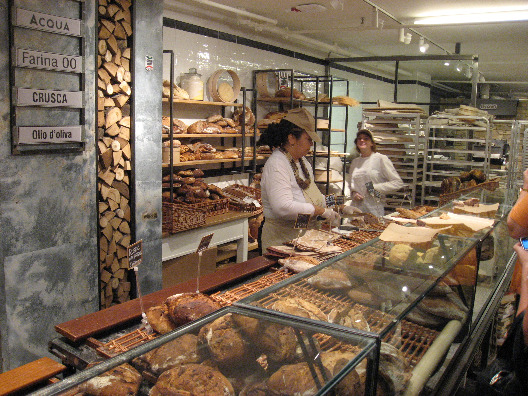 Bakers serve up warm, fresh bread from the oven at Chef Mario Batali's restaurant