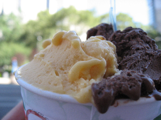 Cup of chocolate and almond gelato served with a spoon