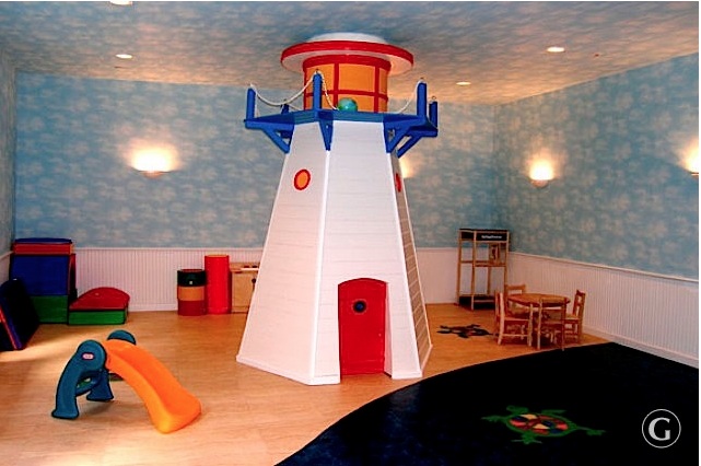 Glenwood's family friendly apartment in NYC features a cloud painted room with a giant lighthouse, plastic slide, foam matting, and reading table and chairs