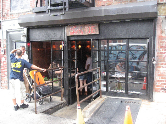 Fatt Cue in Williamsburg exterior black trim and small windows on brick facade