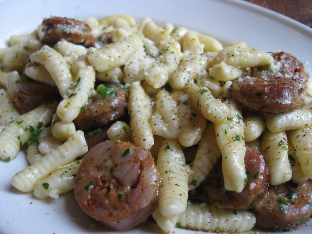 Frankies Spuntino pasta with sausage and nuts in a creamy sauce sprinkled with herbs