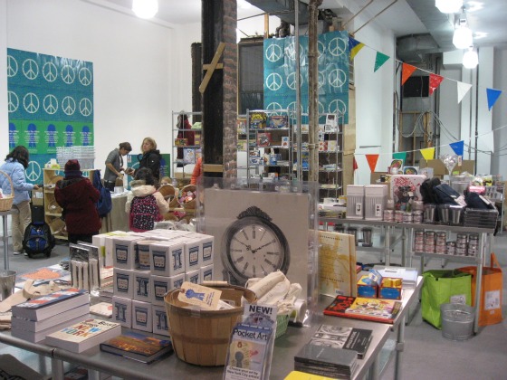 Inside the Blue Ribbon General Store packed full of tables with clocks, artwork, books and fun gifts 