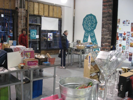 A giant martini glass in the foreground and tables filled with holiday shoppping goodies