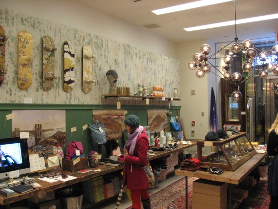 A young women looking at the gifts available at the Cool Hunting holiday shopping pop up