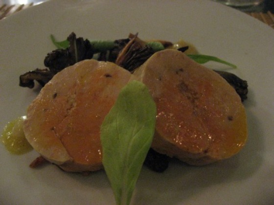 Hung Ry in NYC serves up monkfish liver cakes with mushrooms and berry drizzle on a white plate with greens