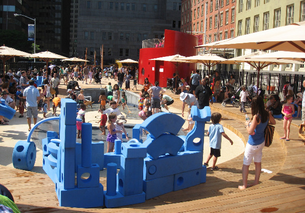 Crowd gathers around blue foam building blocks at the imagination playground in NYC