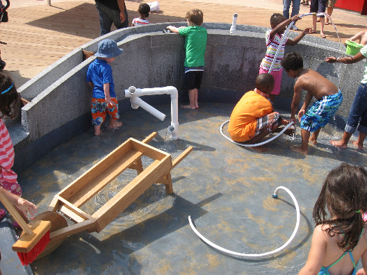The water area of the Imagination Playground lets kids play with hoses or various sizes and water pressure