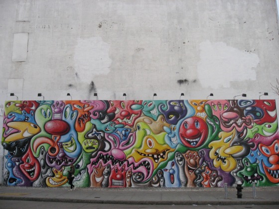 View from Houston Street of Kenny Scharf artist mural in colorful smiling faces