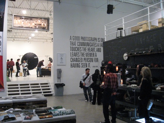 Interior of Levi's Photo Workshop a group of students gather around computer monitors while another group sets up equipment in the background