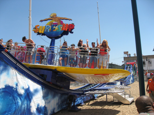 Coney Island Amusement Park Surfs Up ride where riders stand while surfing and twisting
