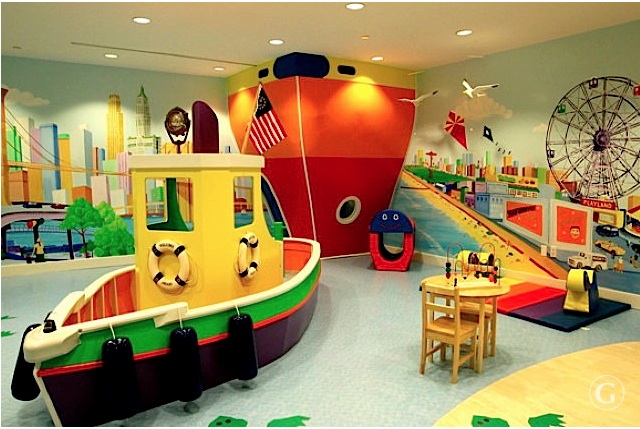 Apartment amenities include this kids playroom with life size boat, climbing tower, and painting of the manhattan skyline on the walls
