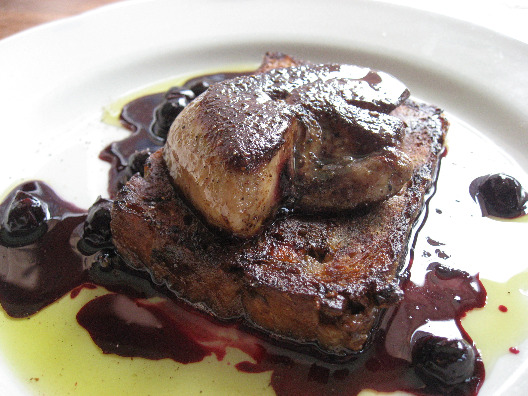Hugue DuFour and Sarah Obraitis serve up a plate of mushroom bread pudding topped with foie fras and drizzled with warm blueberry reduction sauce