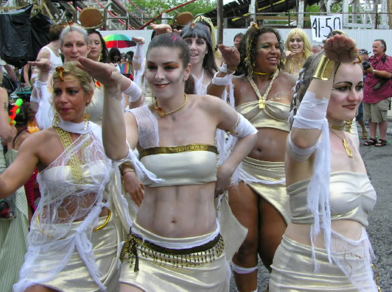 Coney Island Mermaids in white and gold tube tops and skirts dance like Egyptians