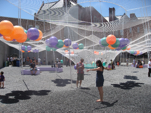 PS1 NYC features architectural design by Solid Objectives with poles to make rubber balls dance