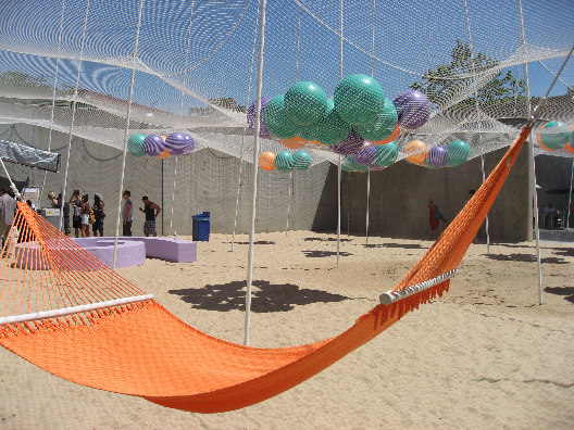 Orange hammock to lounge on with Solid Objective Pole Dance in the background