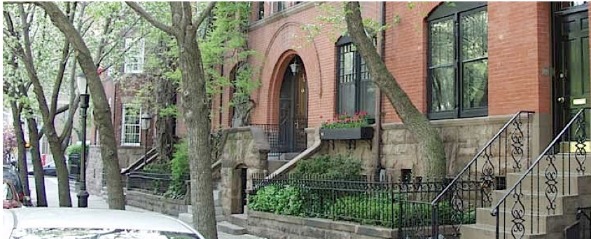 Exterior shot of a brownstone brick building with wrought iron hand rails in NYC is the perfect place to look at when moving to Manhattan