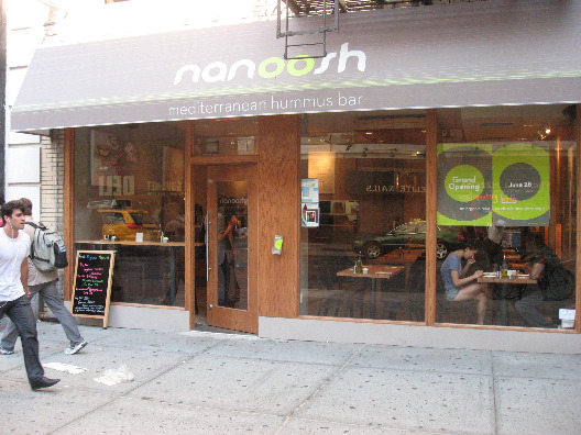 Nanoosh New York close-up of exterior with wood trim and large glass windows
