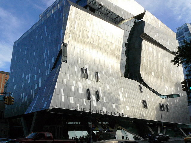 New York City architecture building the Cooper Union reflects silvery light off of its sweeping roofline