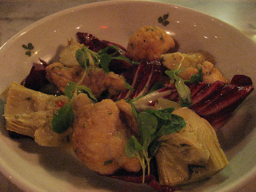 Rabbit pan fried and served with artichokes and radicchio with sage garnish at Osteria Morini
