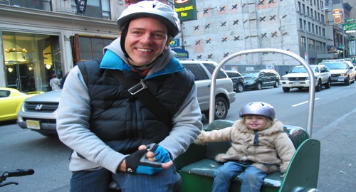 Colin Beaven and daughter Isabella riding around NYC on a bicycle with an attached seat