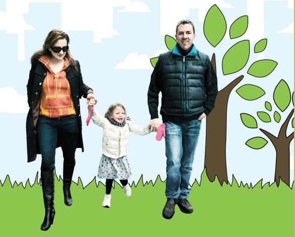 Colin Beaven, Michelle Conlin and twoe year old daughter Isabella holding handing in front of a cartoon background with grass and trees