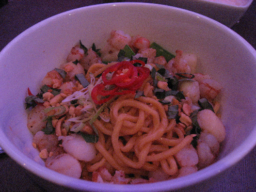 Restaurant i in NYC serves up egg noodle, snow peas, and peanuts sprinkled with dried peppers served in a large white bowl