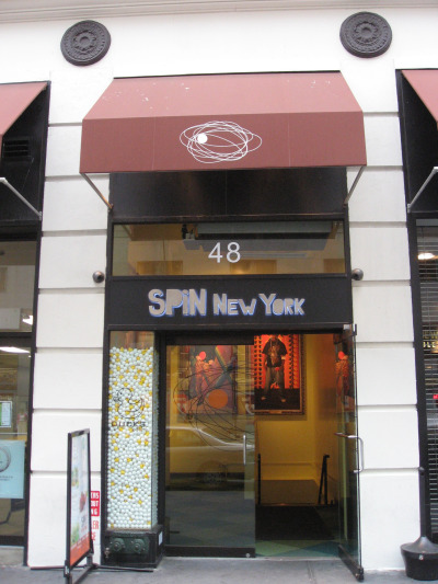 Spin NYC is a table tennis club in the flatiron district with a red awning and fun images on the walls
