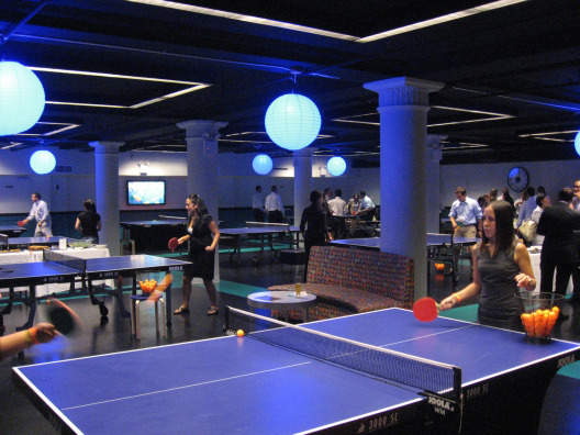 Spin ping pong tables offer visitors hours of fun with paddles and orange balls in a spacious interior