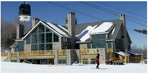 Man skiing by the ski lodge at the Urban Sherpa, a host of NYC Ski Trips 