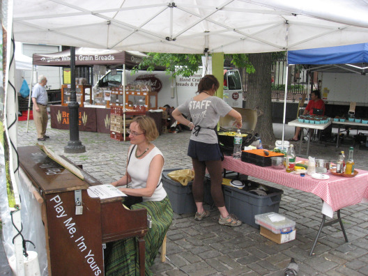 Street Piano players at a street fair with food vendors