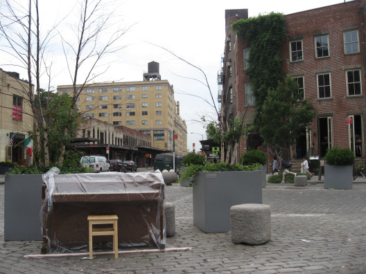 Luke Jerram Street Pianos covered up in the rain on the streets of NYC