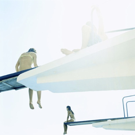 Swimmers on diving boards over a pool photograph at the Bonni Benrubi Gallery NYC