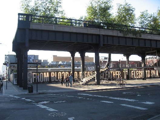 View of Babra Kruger giant text public art works under a bridge in downtown Manhattan