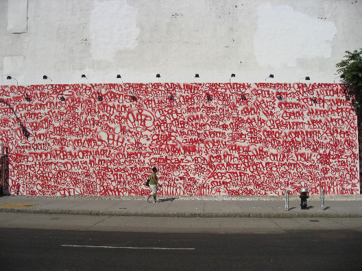 Public art project by Twist and Amaze - a hundres or so simple spray paint tags on a concrete wall