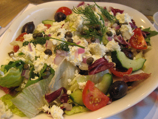 Vapiano Restaurant serves up a greek salad with lettuce, tomatoes, feta cheese, olives and garnish